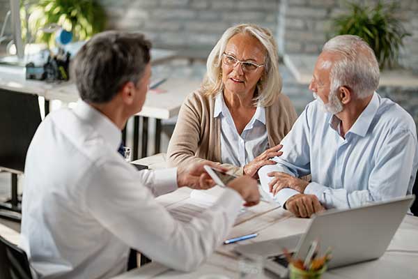 wealth advisor talking to retired couple